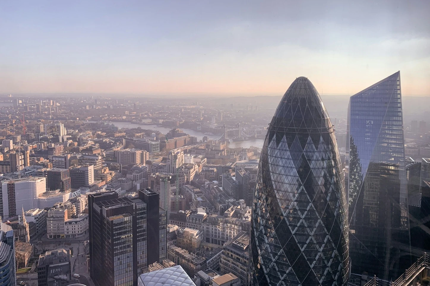 The Gherkin and City of London skyline in soft sunlight